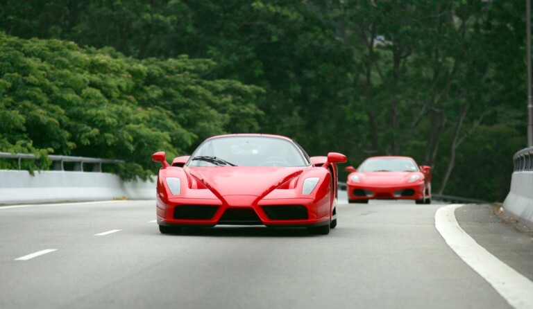 Red Ferrari Enzo and F430 on the road in Singapore
